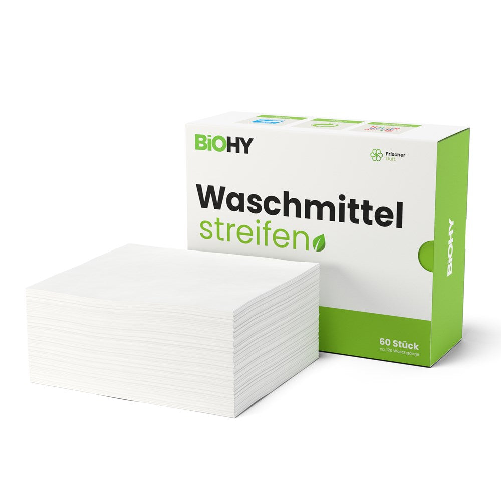 Weisse waschmittelstreifen mit grün-weisser Kartonverpackung