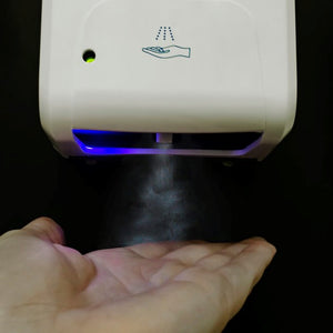 Hand, die den Desinfektionsmittel Spender benutzt